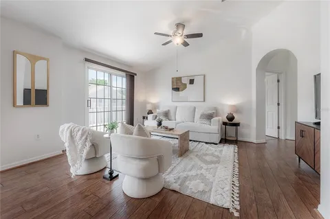 a living room with furniture and wooden floor