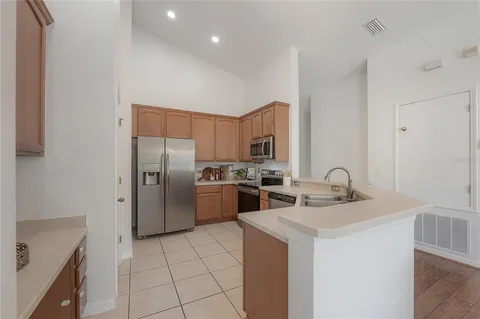 a kitchen with stainless steel appliances a refrigerator sink and stove
