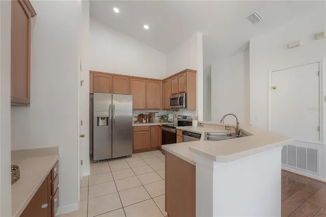 a kitchen with stainless steel appliances a refrigerator sink and stove