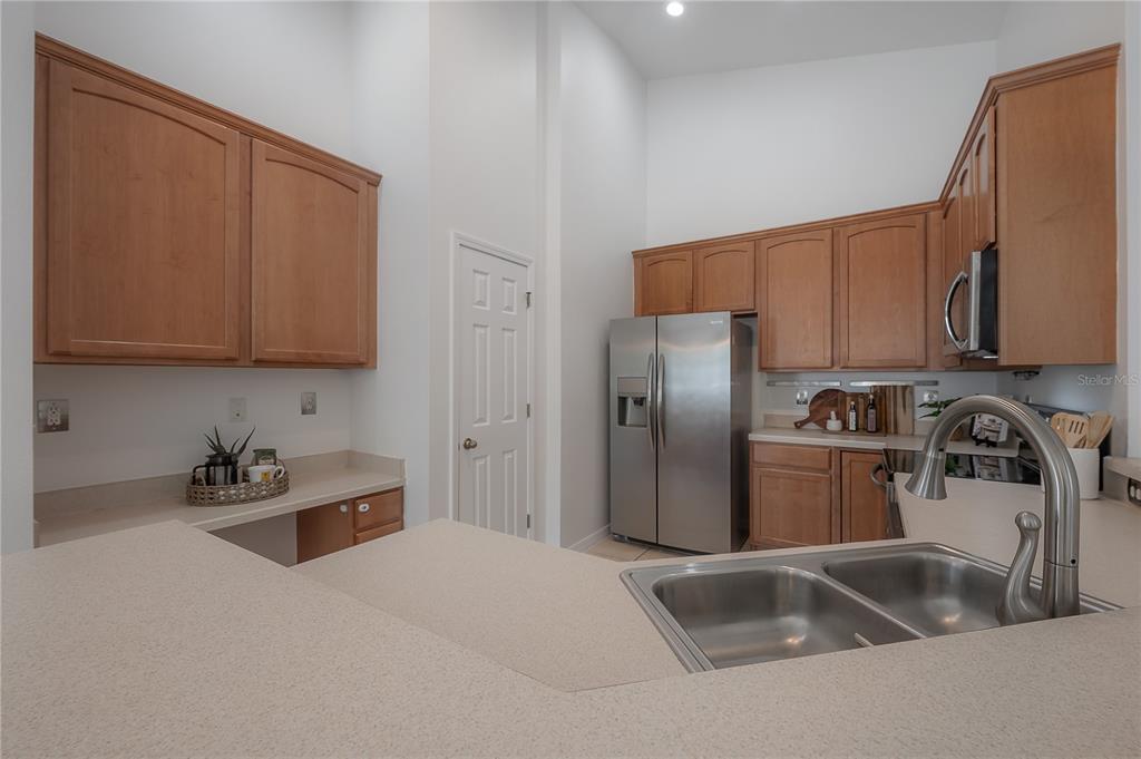 27834 Pleasure Ride Loop Wesley Chapel, FL 33544 - Photo 8 of 25 a kitchen with stainless steel appliances granite countertop a sink a refrigerator and a stove top oven