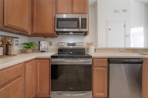 a kitchen with stainless steel appliances granite countertop a stove and a microwave
