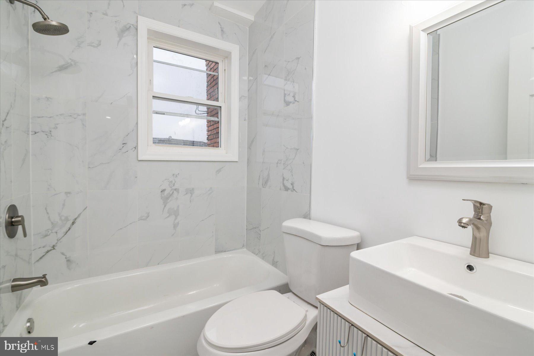 62 Gorman Avenue Baltimore, MD 21223 - Photo 21 of 24 a bathroom with a toilet a sink and bathtub