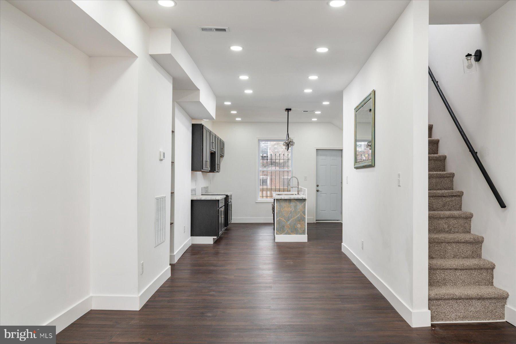 62 Gorman Avenue Baltimore, MD 21223 - Photo 7 of 24 a view of a kitchen with refrigerator and wooden floor