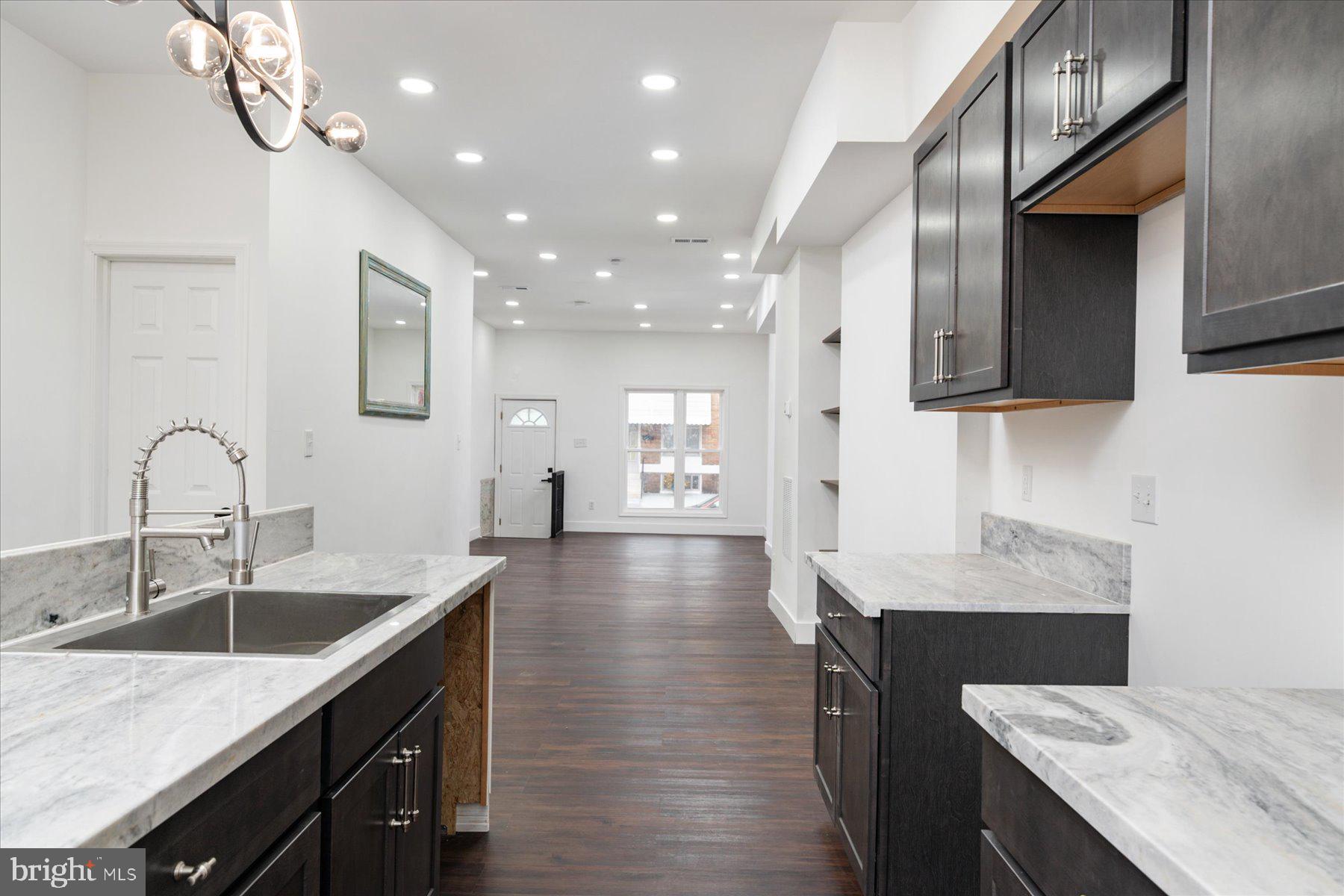 62 Gorman Avenue Baltimore, MD 21223 - Photo 10 of 24 a kitchen with a sink stove and cabinets
