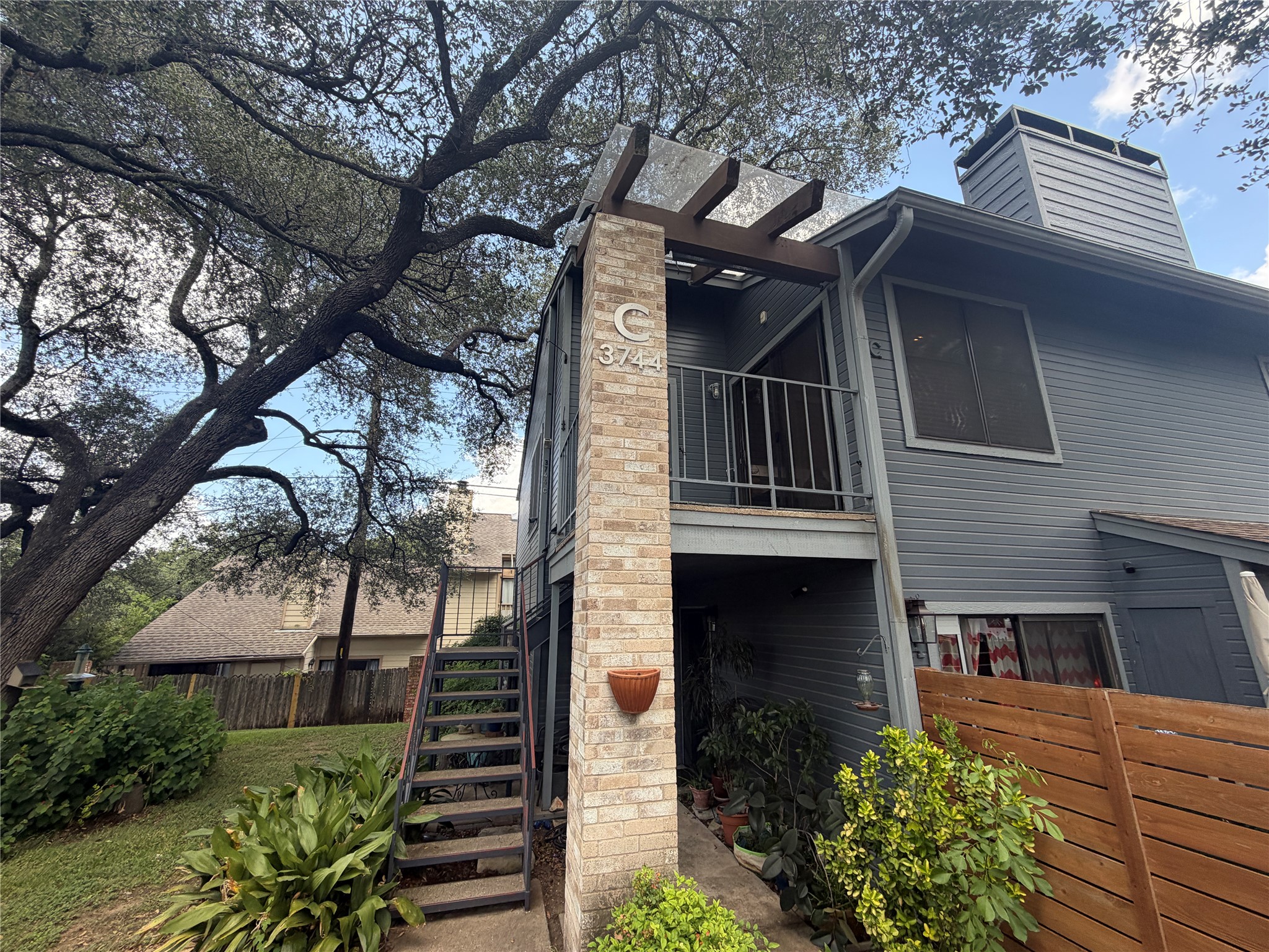 3744 Valley View Road, Unit C Austin, TX 78704 - Photo 5 of 25 a front view of a house with a garden