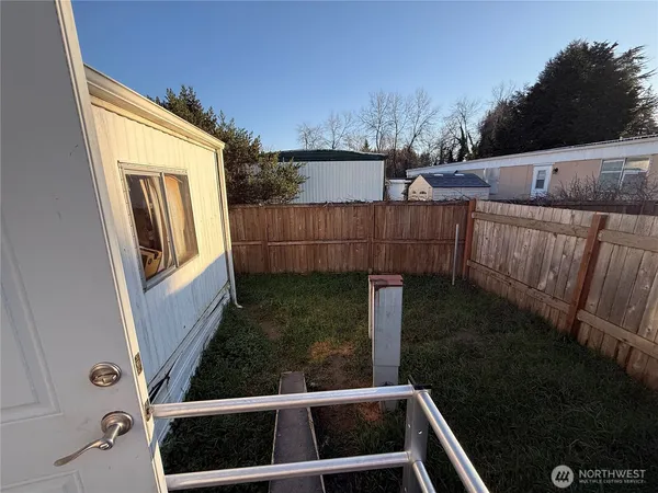 a view of living room with furniture and a mirror