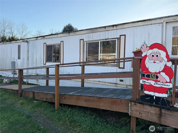 a view of a house with backyard and wooden fence