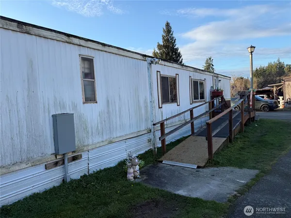a wooden bench sitting in front of a house