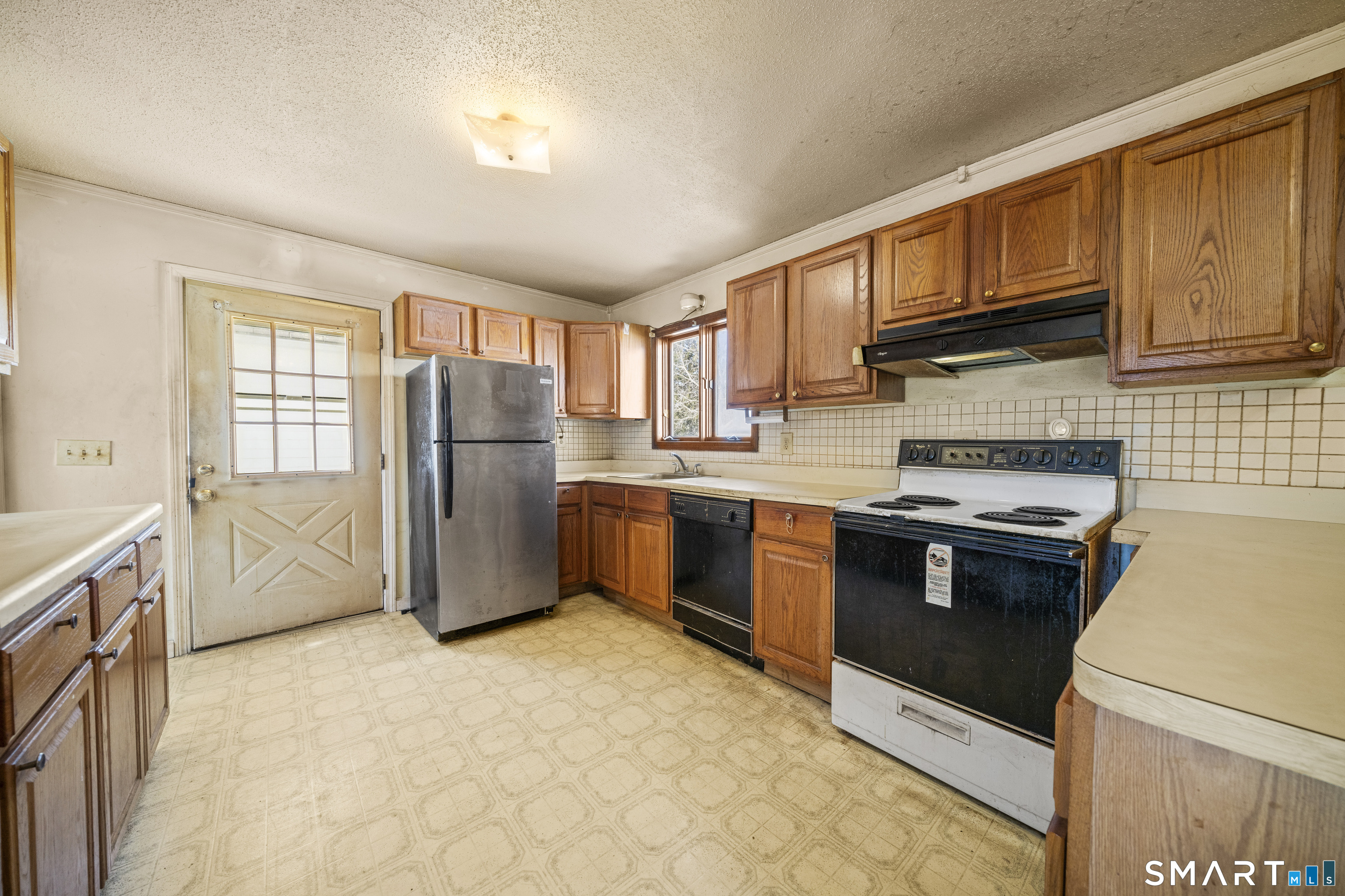 56 South River Street Enfield, CT 06082 - Photo 15 of 38 a kitchen with stainless steel appliances granite countertop a refrigerator stove and sink