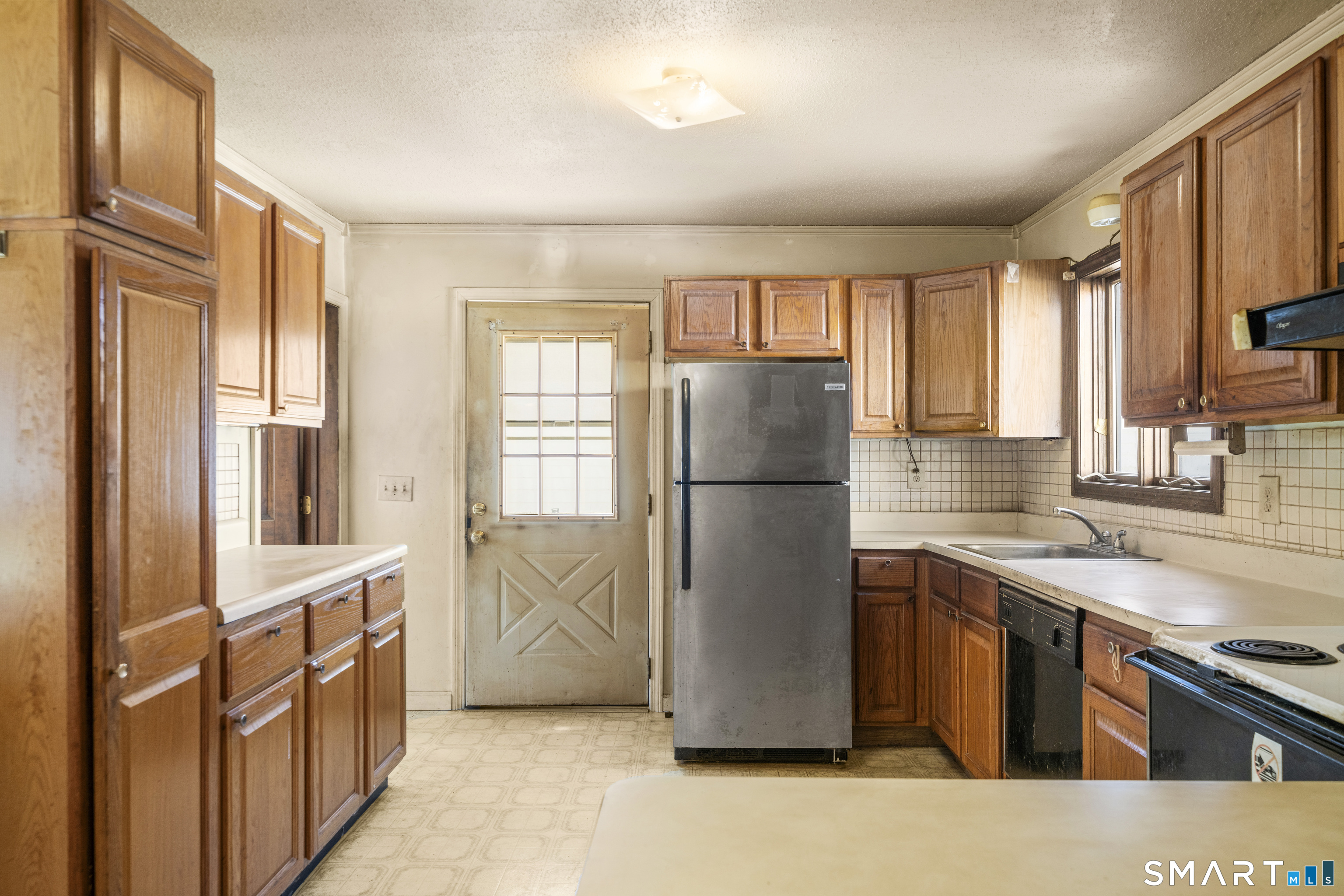 56 South River Street Enfield, CT 06082 - Photo 16 of 38 a kitchen with a refrigerator a sink and dishwasher