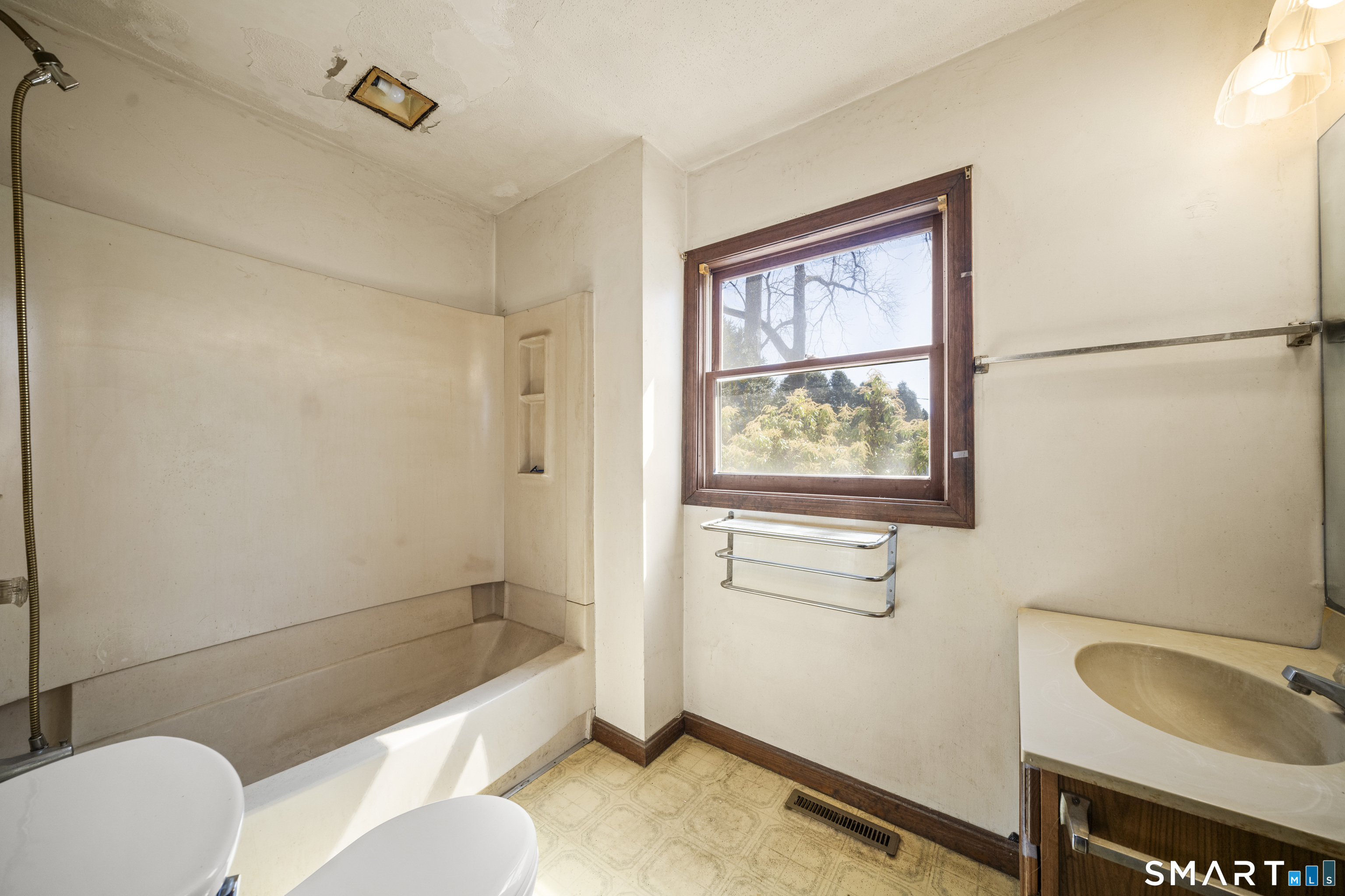 56 South River Street Enfield, CT 06082 - Photo 22 of 38 a bathroom with a sink mirror bathtub and toilet