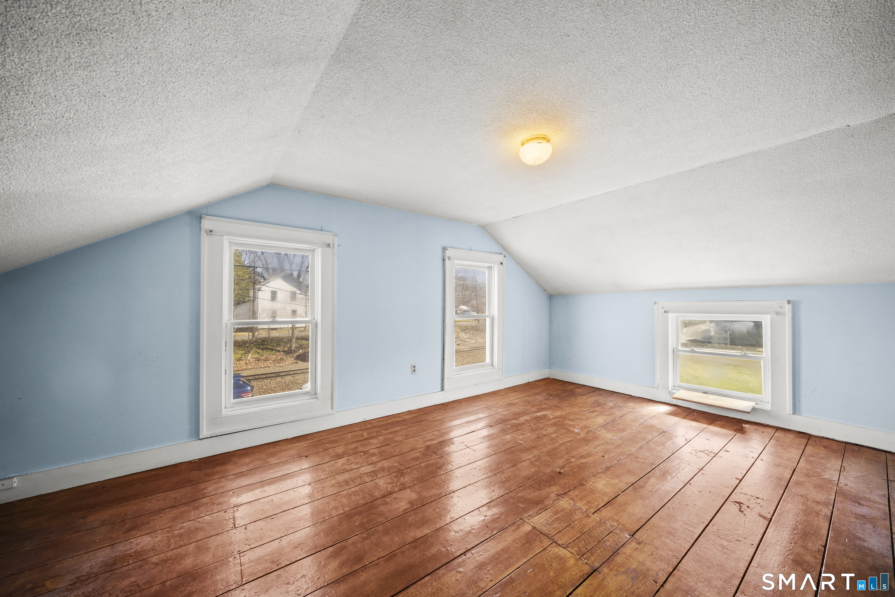 56 South River Street Enfield, CT 06082 - Photo 34 of 38 an empty room with wooden floor and windows