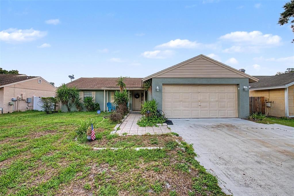 1632 Pintail Court Lutz, FL 33549 - Photo 1 of 34 a front view of a house with a yard and garage