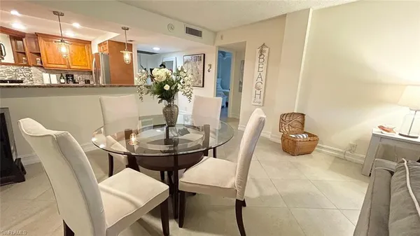 a view of a dining room with furniture and a chandelier