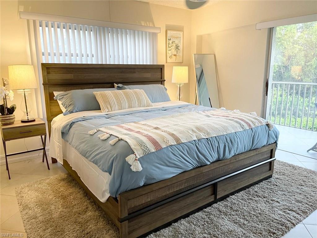 1 Bluebill Avenue, Unit 210 Naples, FL 34108 - Photo 14 of 17 a bed sitting in a bedroom next to a window