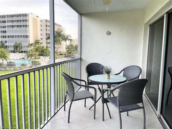 a view of a balcony furniture and dining room