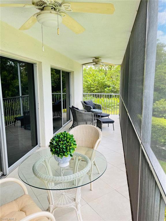 1 Bluebill Avenue, Unit 210 Naples, FL 34108 - Photo 3 of 17 a living room with furniture and a large window