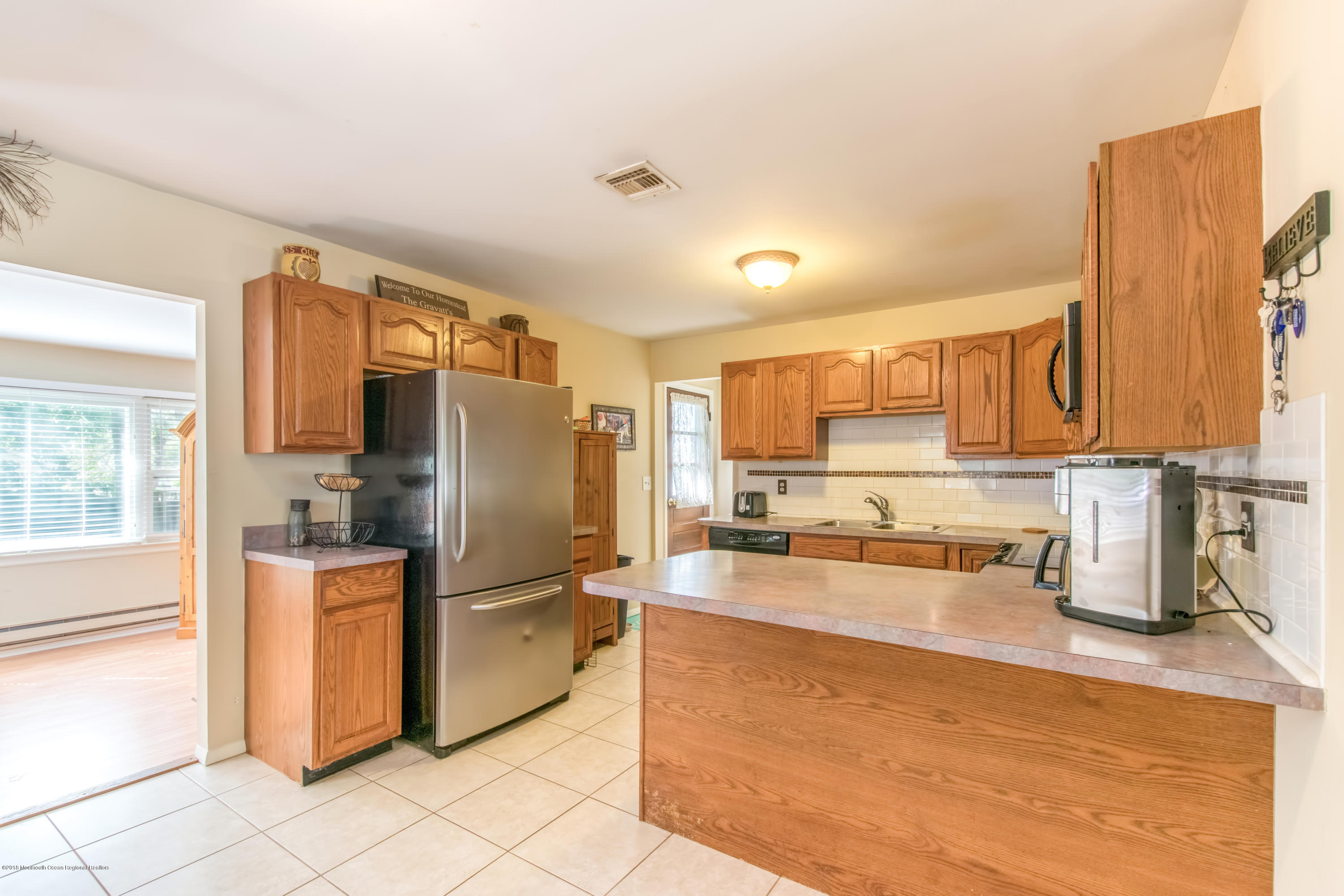 156 Captain Road Manahawkin, NJ 08050 - Photo 13 of 39 a kitchen with granite countertop a refrigerator and a sink