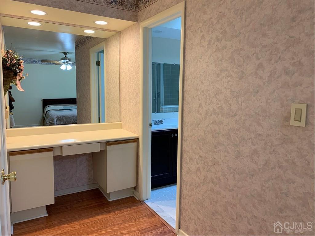 4702 Stonehedge Road Edison, NJ 08820 - Photo 15 of 24 a bathroom with a sink and a mirror