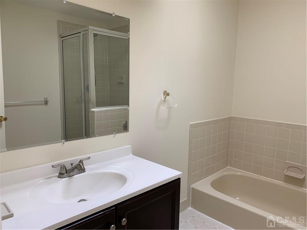 4702 Stonehedge Road Edison, NJ 08820 - Photo 16 of 24 a bathroom with a sink and a bathtub