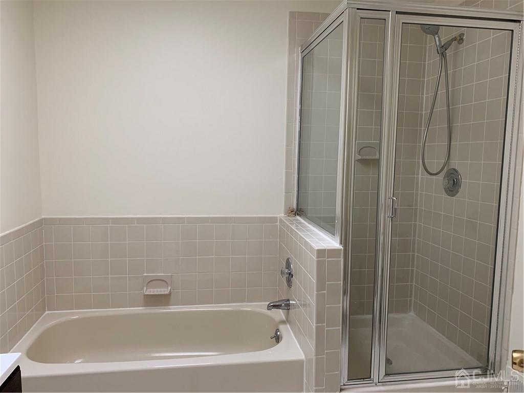 4702 Stonehedge Road Edison, NJ 08820 - Photo 17 of 24 a bathroom with a shower and a bathtub