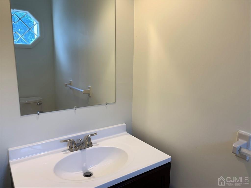 4702 Stonehedge Road Edison, NJ 08820 - Photo 24 of 24 a bathroom with a sink and a mirror