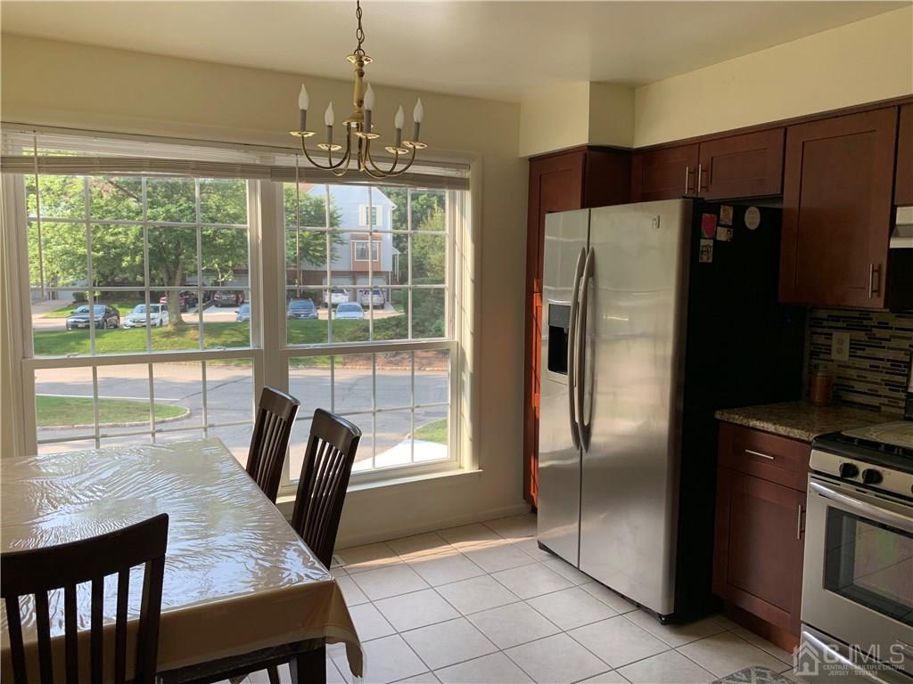 4702 Stonehedge Road Edison, NJ 08820 - Photo 5 of 24 a kitchen with kitchen island a counter top space and stainless steel appliances