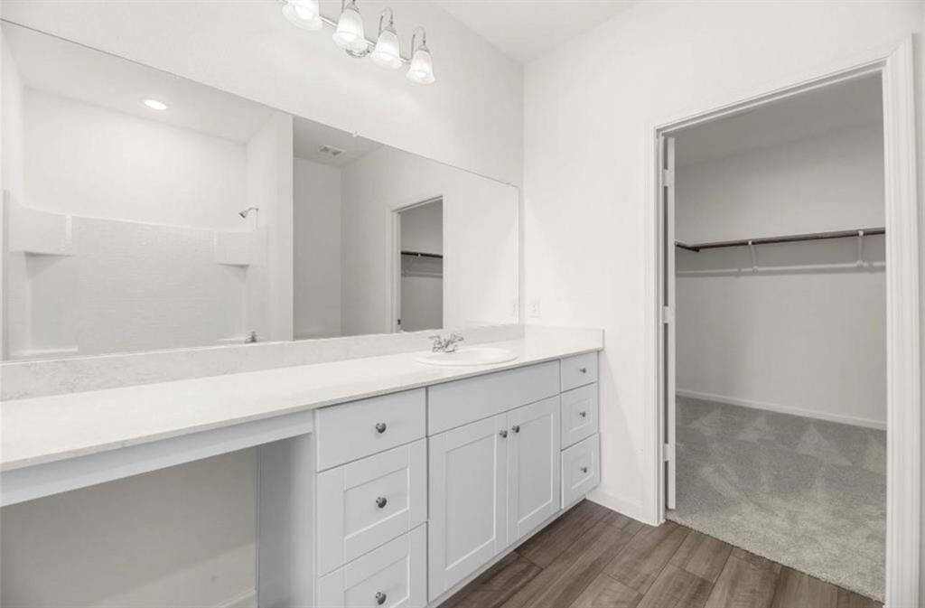 10308 Holy Cross Lane Crowley, TX 76036 - Photo 22 of 27 a bathroom with a double vanity sink and mirror