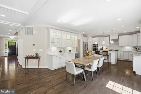 a living room with furniture a clock on wall and a table