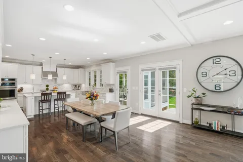 a dining table with chairs and wooden floor