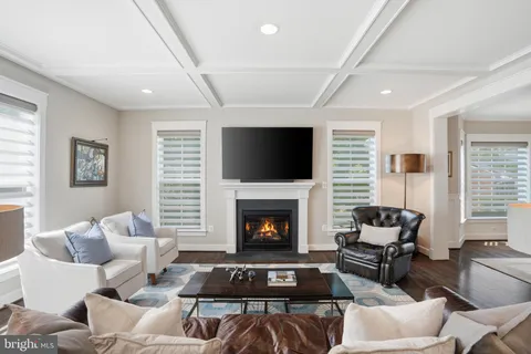 a living room with fireplace furniture and a flat screen tv