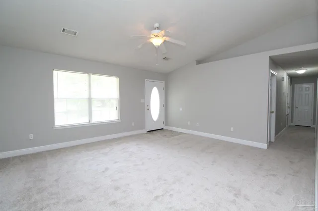 a view of an empty room with a window