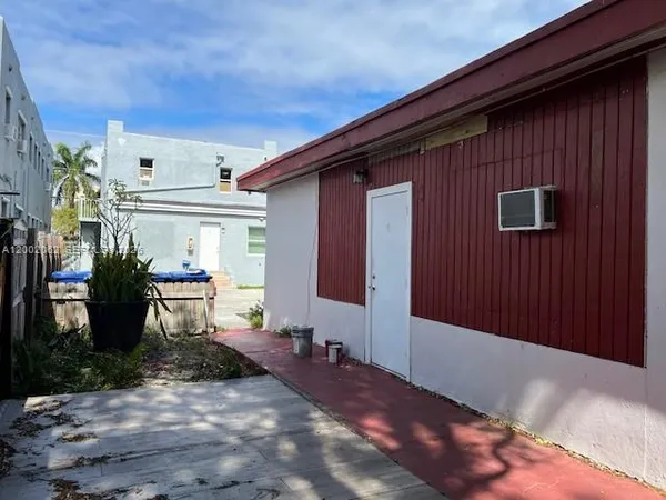 a backyard of a house with table and chairs