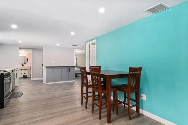 a view of a dining room with furniture and wooden floor
