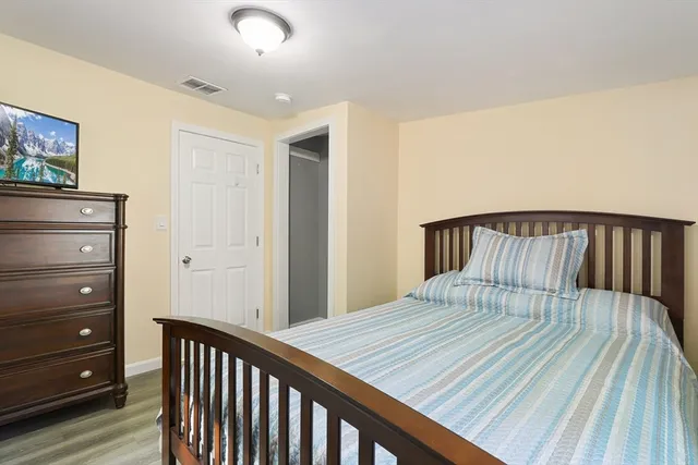 a bedroom with a bed and a dresser