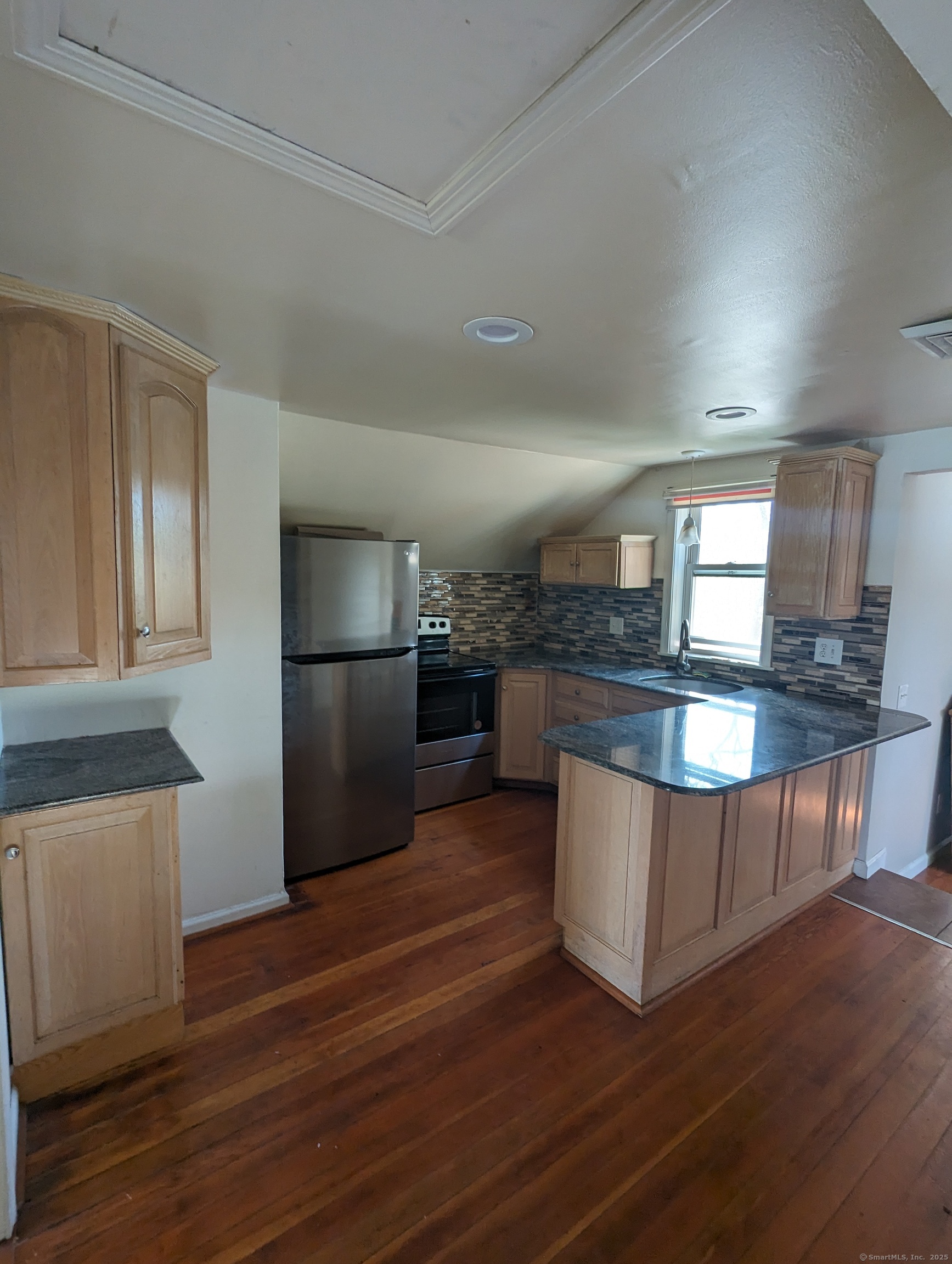 99 River Road, Unit 2 Windsor Locks, CT 06096 - Photo 2 of 6 a kitchen with stainless steel appliances granite countertop a stove a sink and a refrigerator