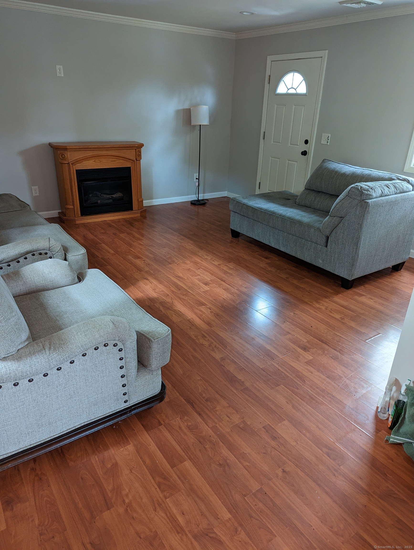 99 River Road, Unit 2 Windsor Locks, CT 06096 - Photo 3 of 6 a living room with furniture and a fireplace