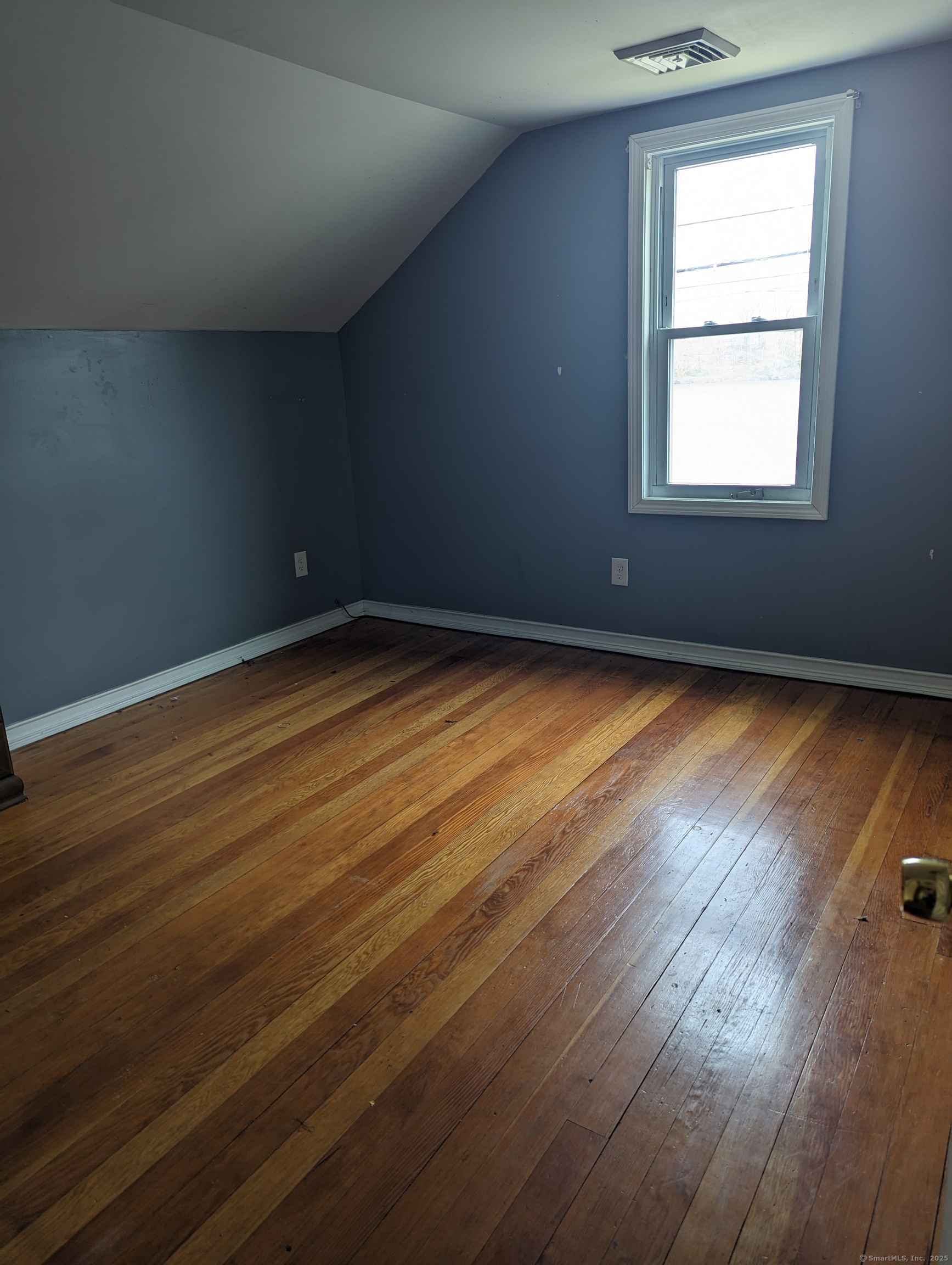 99 River Road, Unit 2 Windsor Locks, CT 06096 - Photo 4 of 6 a view of an empty room with wooden floor and a window
