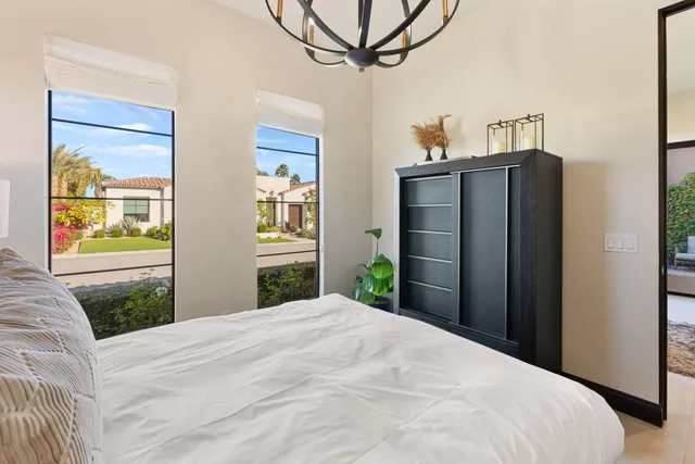 a bedroom with a bed and a chandelier