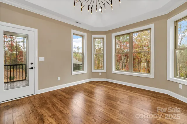 a kitchen with a sink dishwasher a stove and a refrigerator with wooden floor