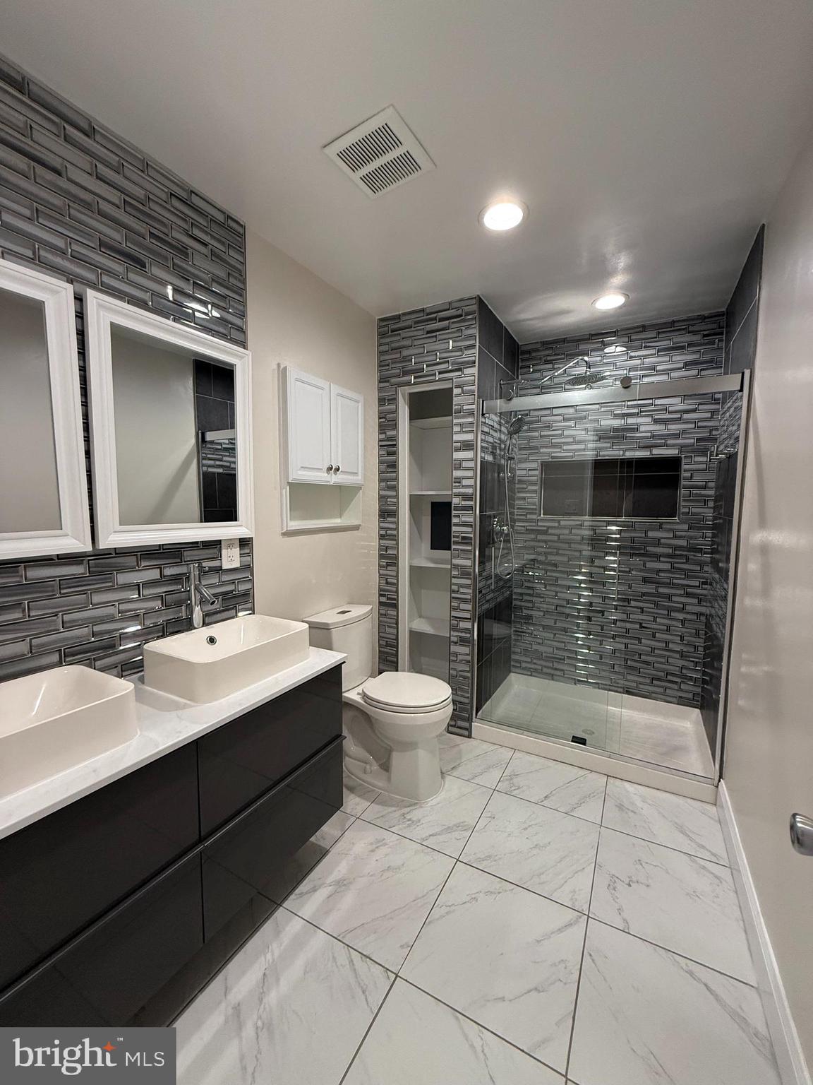 3801 Tremayne Terrace Silver Spring, MD 20906 - Photo 14 of 25 a bathroom with a sink a toilet and shower