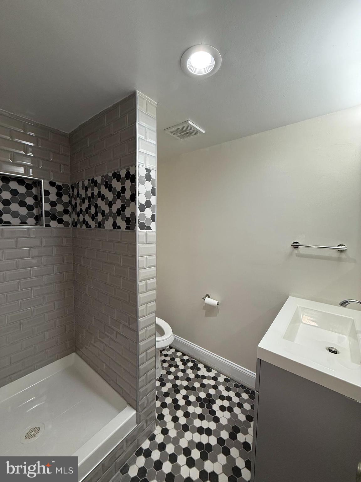 3801 Tremayne Terrace Silver Spring, MD 20906 - Photo 21 of 25 a bathroom with a sink a toilet and shower