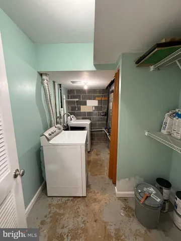 a room with a washing machine and storage