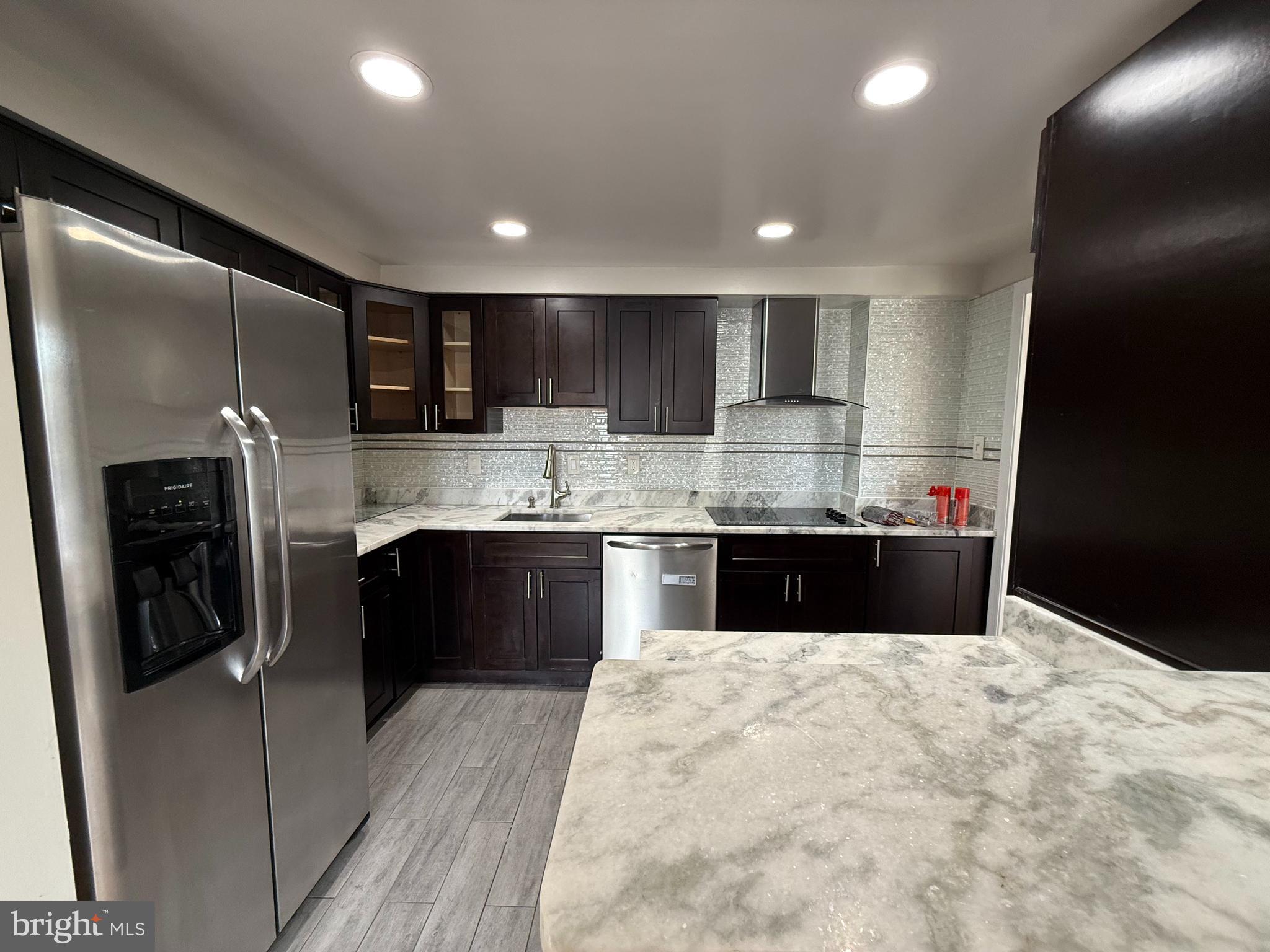 3801 Tremayne Terrace Silver Spring, MD 20906 - Photo 5 of 25 a bathroom with a sink a large mirror and a refrigerator