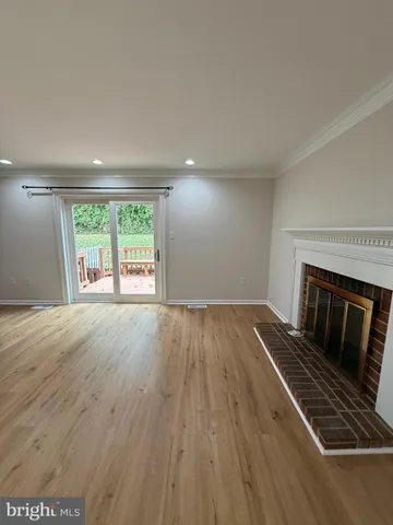 wooden floor in an empty room with a fireplace