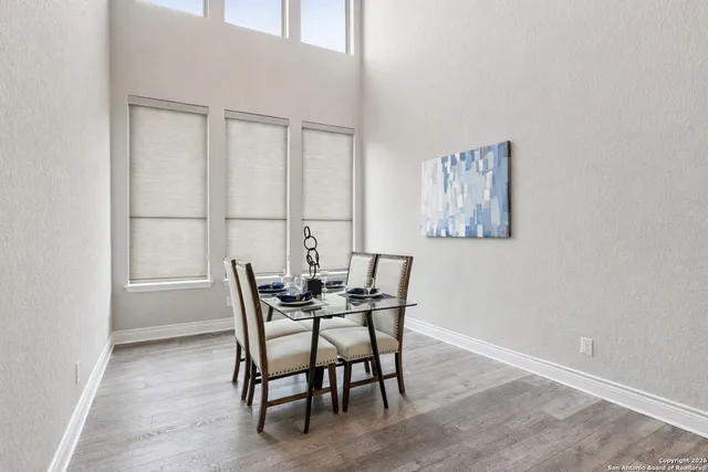 a view of a dining room with furniture and wooden floor