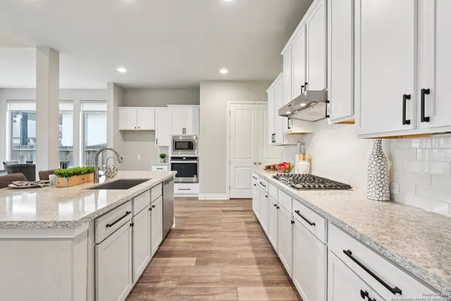 a kitchen with a sink a counter top space and appliances