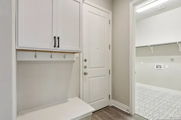 a view of kitchen with cabinets and wooden floor