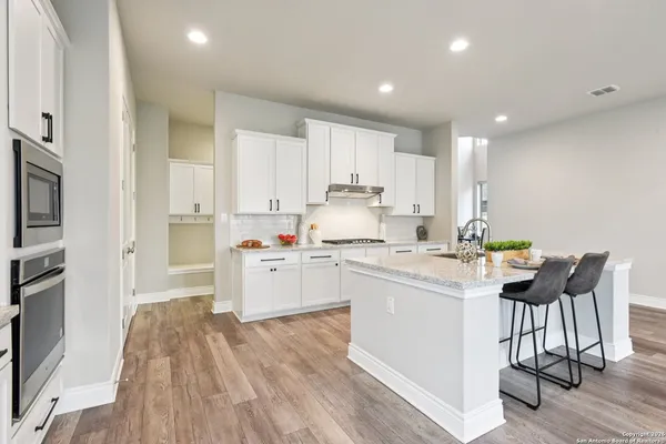 a living room with a fireplace and wooden floor