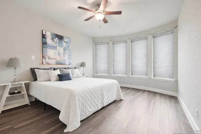 a spacious bathroom with a shower sink and mirror